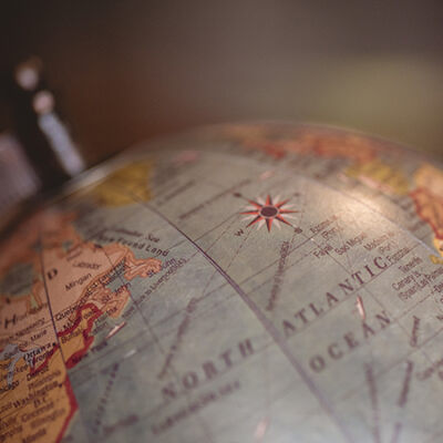 closeup-shot-of-a-desk-globe-with-a-blurred-background